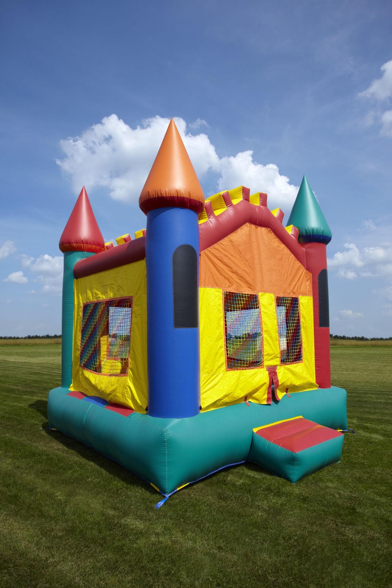 Colorful bounce house set up outdoors on grass
